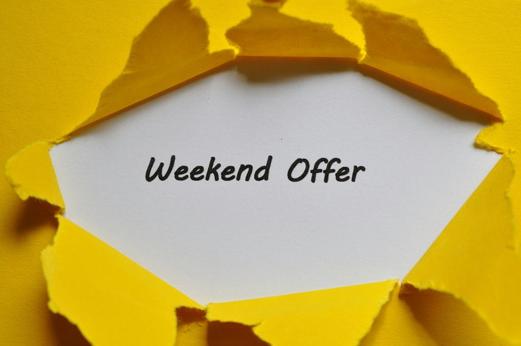 Yellow torn paper uncovering 'Weekend Offer' text. Ideal for promotions.
