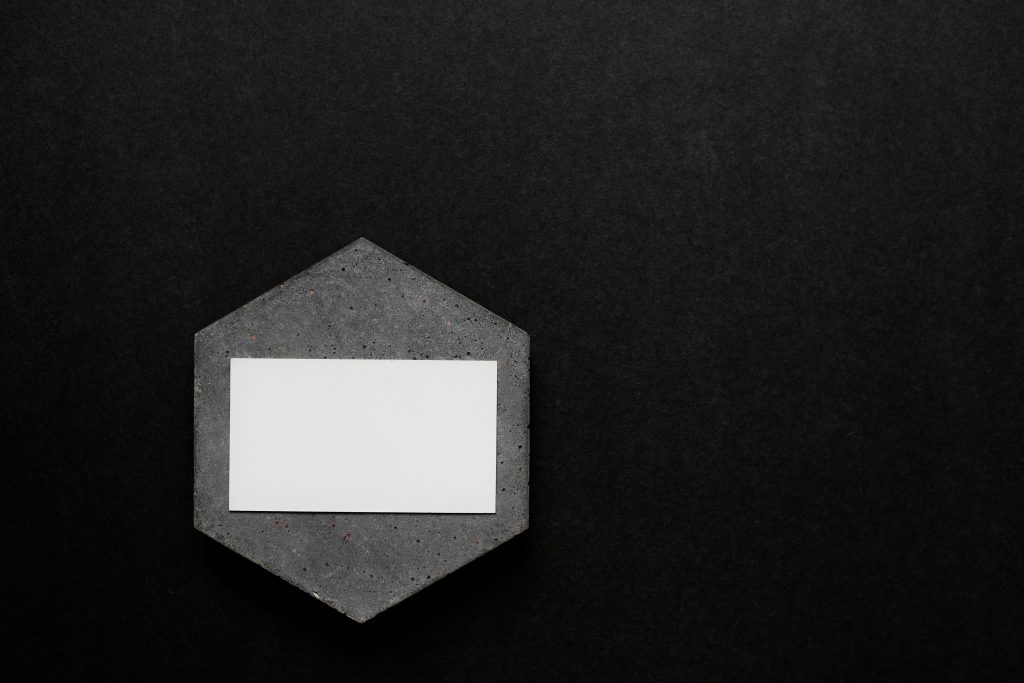 Minimalist business card mockup on hexagonal stone, ideal for branding presentations.